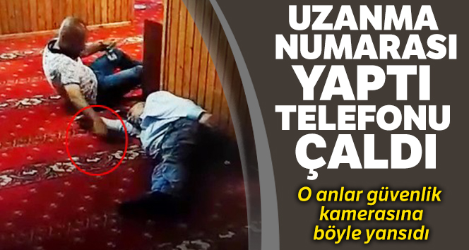 Camide uyuyan şahsın yanına uzanma numarası yapıp telefonunu çaldı