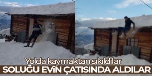 Yolda kaymaktan sıkılan dede ve torunu soluğu evin çatısında aldı