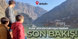 Sular altında kalan evlerine son kez baktılar